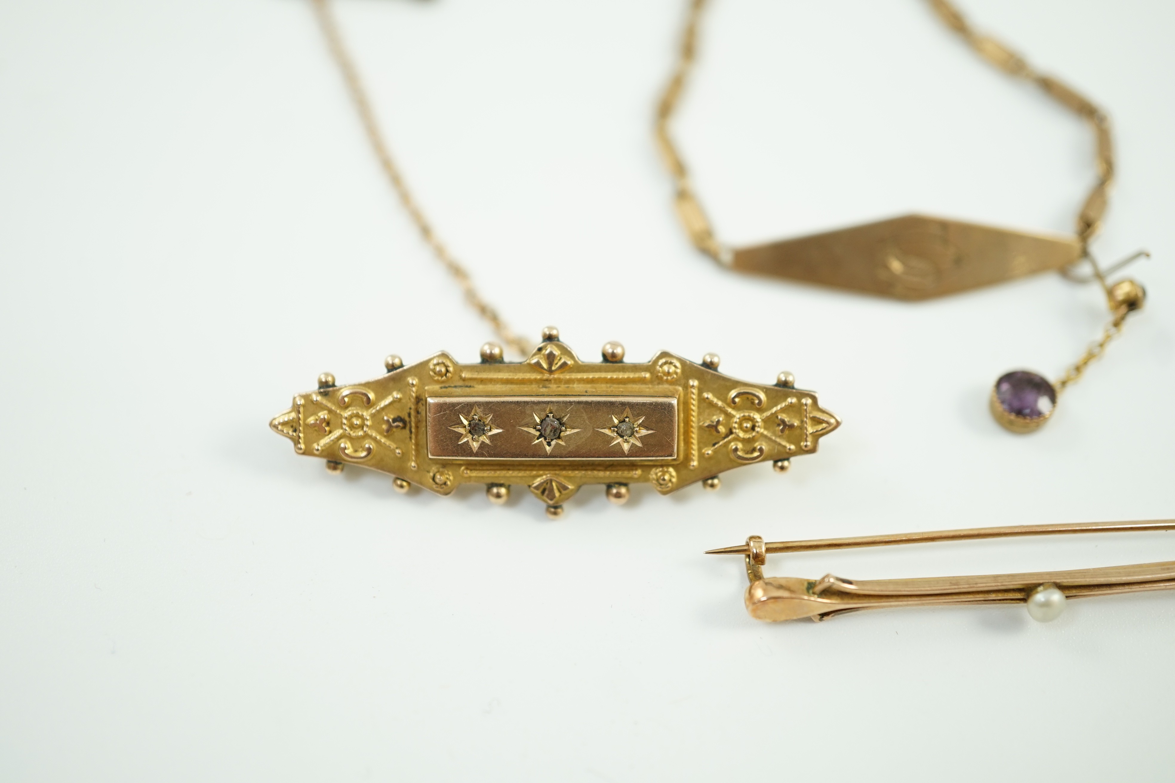 Two early 20th century yellow metal brooches including 9ct and diamond chip set and a seed pearl set bar brooch by Murrle Bennett & Co?, together with a 9ct identity bracelet, gross weight 10.6 grams.